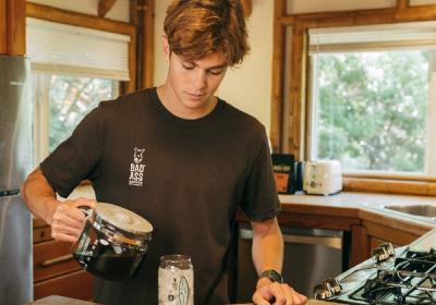 Cole Alves pouring coffee in a kitchen.
