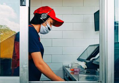 A fast-food worker in the drive-thru window.