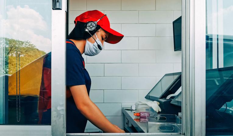 A fast-food worker in the drive-thru window.