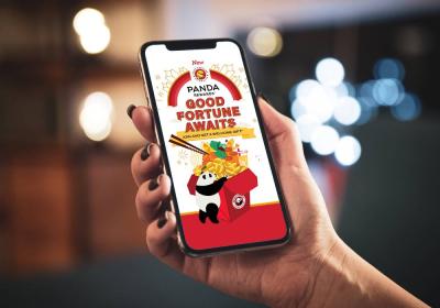 A person holding the phone showing Panda Express' rewards program.